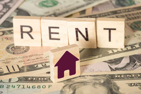 Dollar bills and rent for a houseの写真素材