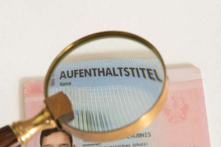 Residence permit under a magnifying glassの写真素材
