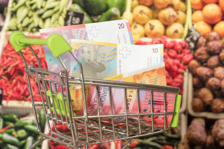 Shopping cart, Swiss Franc CHF and groceriesの写真素材