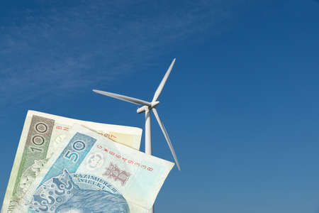 Wind turbine in Poland and banknotes Polish zloty PLN