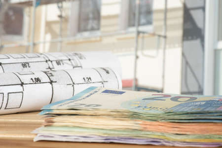 Euro cash draw, construction plans and construction site for a house