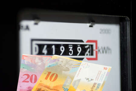 Electricity meter, Swiss franc money and prices for electricity in Switzerlandの写真素材