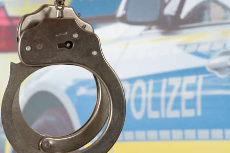 Handcuffs and a police carの写真素材
