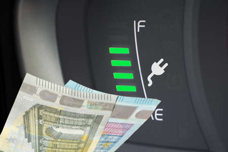 An electric car and euro banknotes
