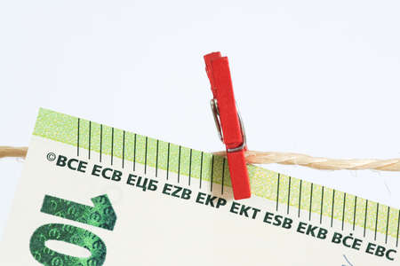Euro bank note, clothesline and money laundering