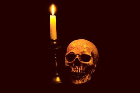 A skull and light of a candleの写真素材