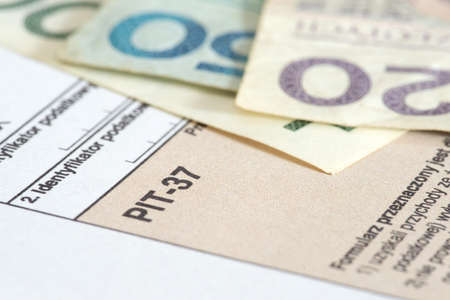 PIT form for tax returns in Poland and Polish zloty banknotesの写真素材
