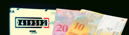 Electric meter and money Swiss francの写真素材
