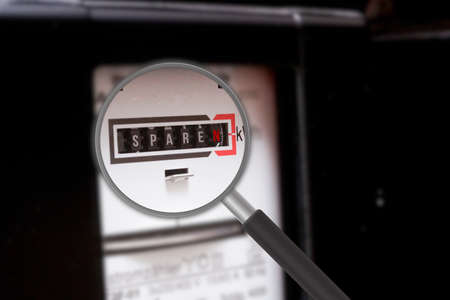 A magnifying glass, electricity meter and saving electricityの写真素材