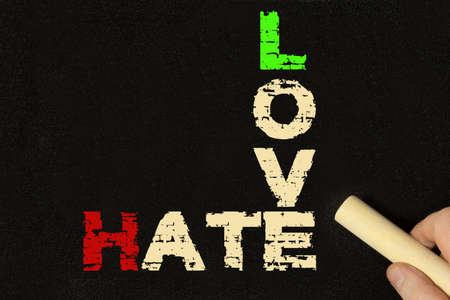 A blackboard with the words hate and loveの写真素材