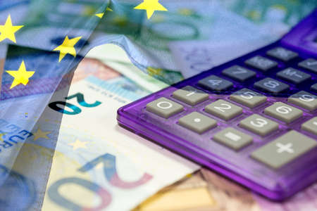 European Union flag, calculator and euro moneyの写真素材