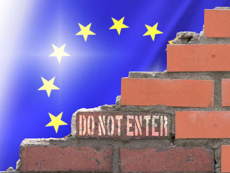 Flag of the European Union, a brick wall and warning of entry