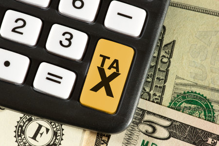 Calculator, dollar bills and taxes in USAの写真素材