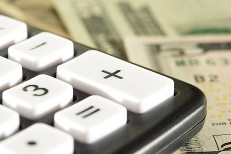 Dollar bills and a calculatorの写真素材
