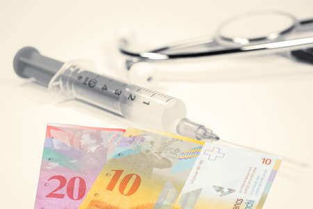 Money Swiss Francs and vaccination against Corona Virusの写真素材