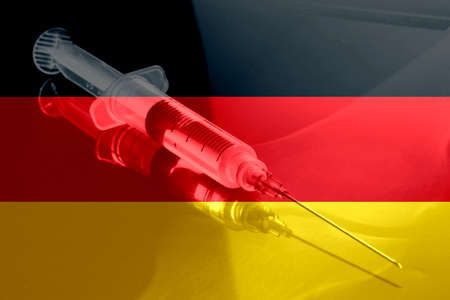 Vaccination against virus, syringe and flag of Germanyの写真素材