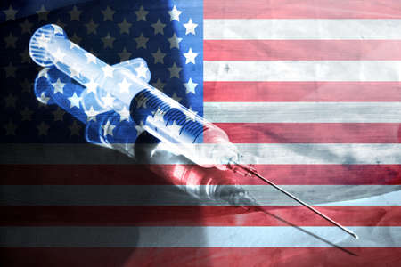 Flag of USA, syringe and vaccination against virusの写真素材