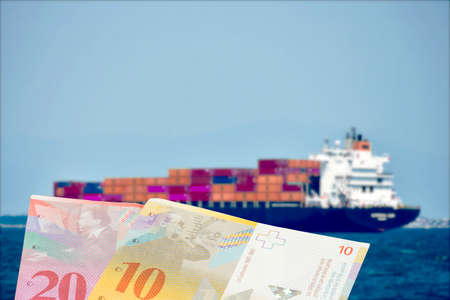 A ship with containers and money Swiss francsの写真素材