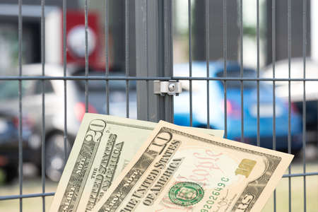 New cars in a dealership and dollar billsの写真素材