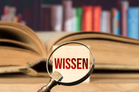 A book, a magnifying glass and knowledge