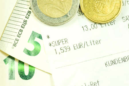 Euro banknotes and coins and receipt from a gas station