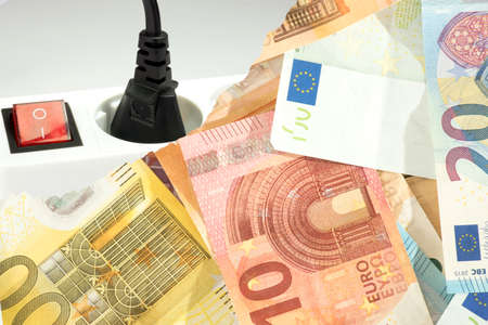 Euro banknotes and a power cord