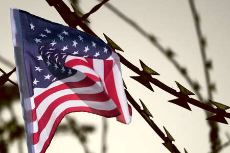 Flag of USA, barbed wire and the borderの写真素材