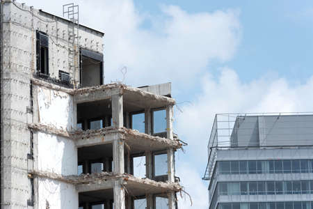 A skyscraper is being demolishedの写真素材