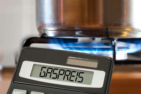 A saucepan on a gas stove, calculator and the price of gasの写真素材