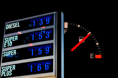 Gasoline prices at the gas station and fuel gauge in the carの写真素材