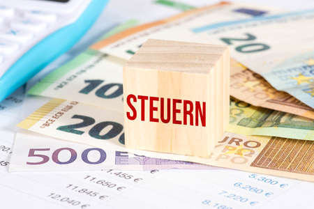 Euro banknotes, calculator and the tax