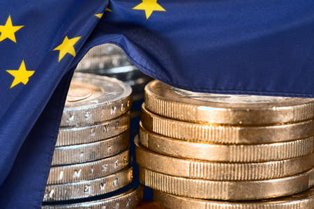 Euro coins and European Union EU flag