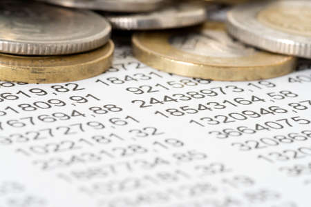 Numbers in a calculation and different coinsの写真素材