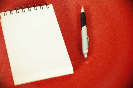 A writing pad and a ballpoint penの写真素材
