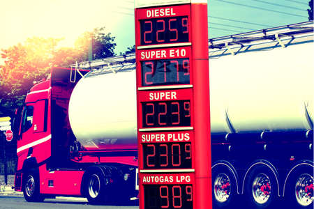 A truck, gas station and high fuel pricesの写真素材