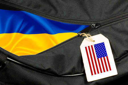 A suitcase and flags of Ukraine and USAの写真素材