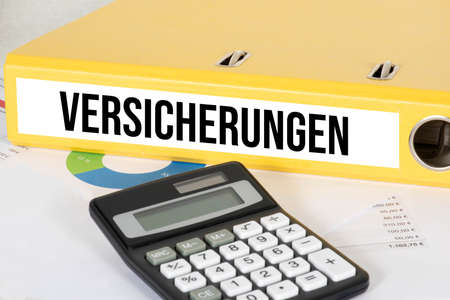 A calculator and folder insuranceの写真素材