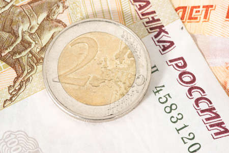 Ruble banknotes and one euro coinの写真素材