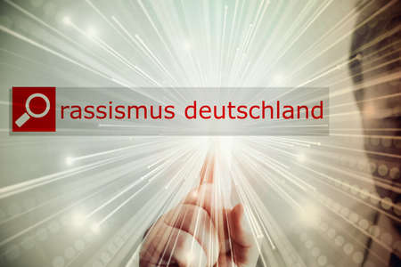 A man searches the Internet for the terms racism and Germanyの写真素材