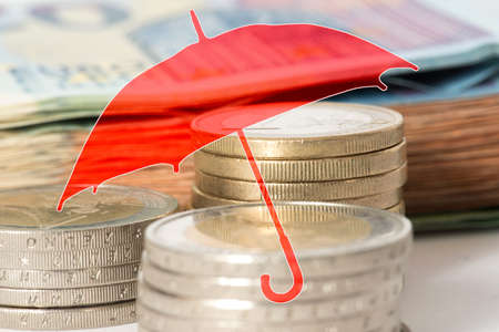 An umbrella and euro bills and coinsの写真素材