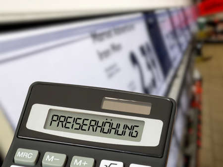 A supermarket, calculator and price increaseの写真素材