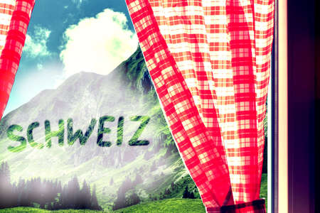 The word is written in red curtains on a background of mountains.の写真素材