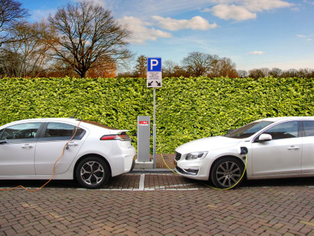 Electric car charging station in the Netherlands with solar panels in the backgroundの写真素材