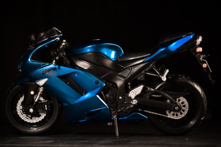 Close-up of a blue sport motorcycle on a black background.の写真素材