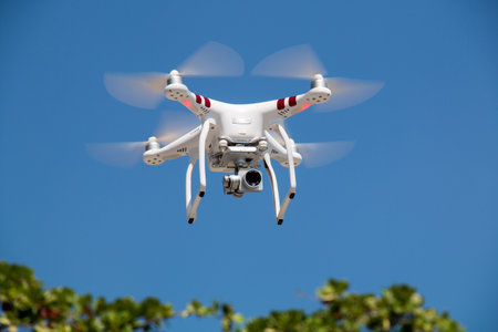 Drone with digital camera flying in the blue sky, quadcopterの写真素材