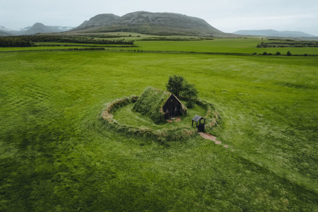 Aerial view of a traditional turf house on a meadow in Icelandの写真素材