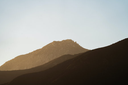 Silhouette of a mountain peak at sunset in the mountains.