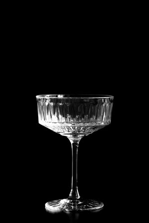 Empty wine glass on a black background. Monochrome image.の写真素材