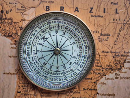 Compass on the old map of the world, close-up