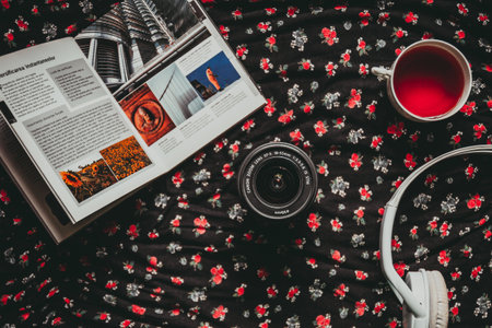 london, england, 05/05/2018 A vintage retro photo camera and a cup of tea lying on a bed with a book. Retro photography.の写真素材